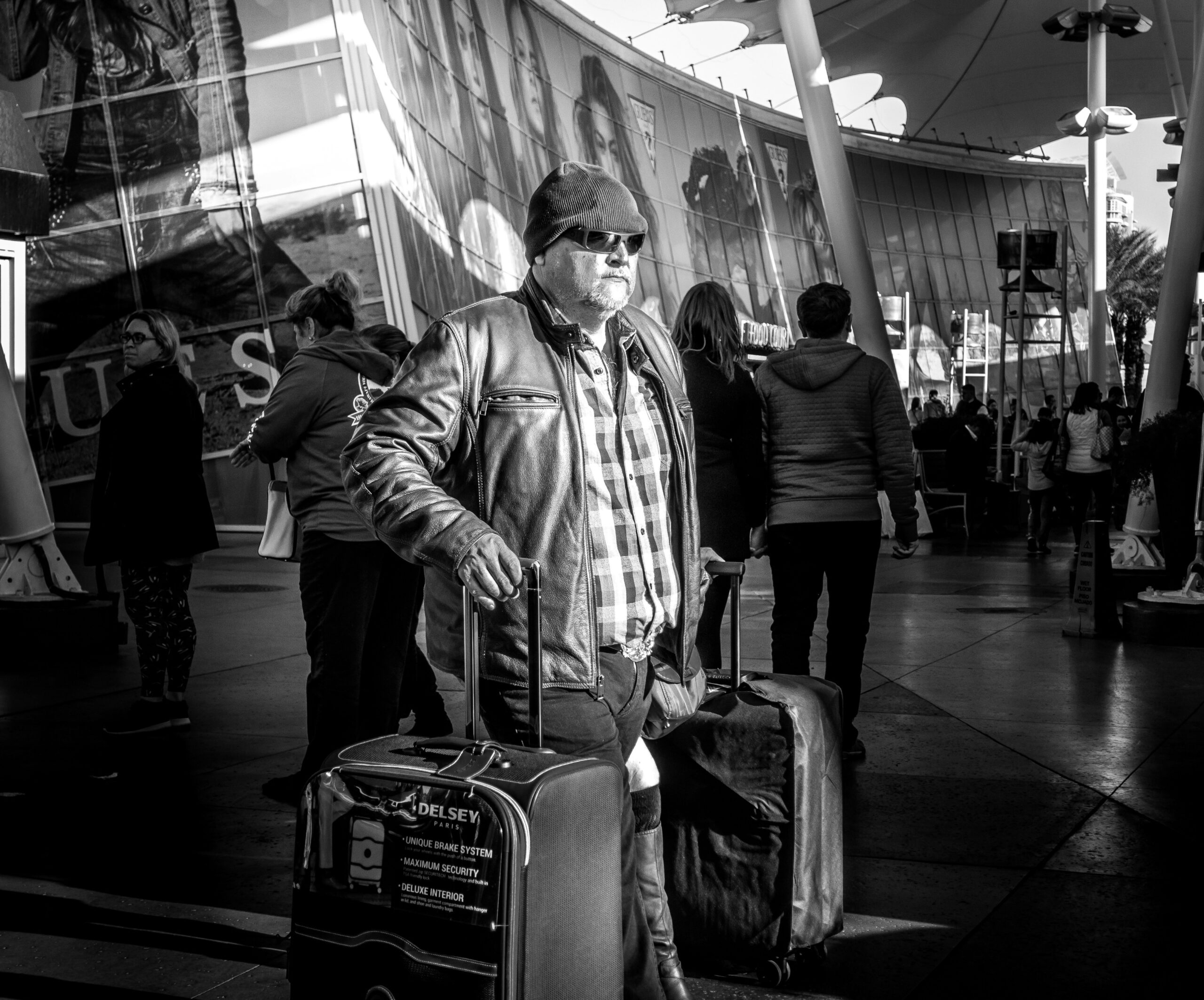 A frustrated traveler standing near a luggage carousel