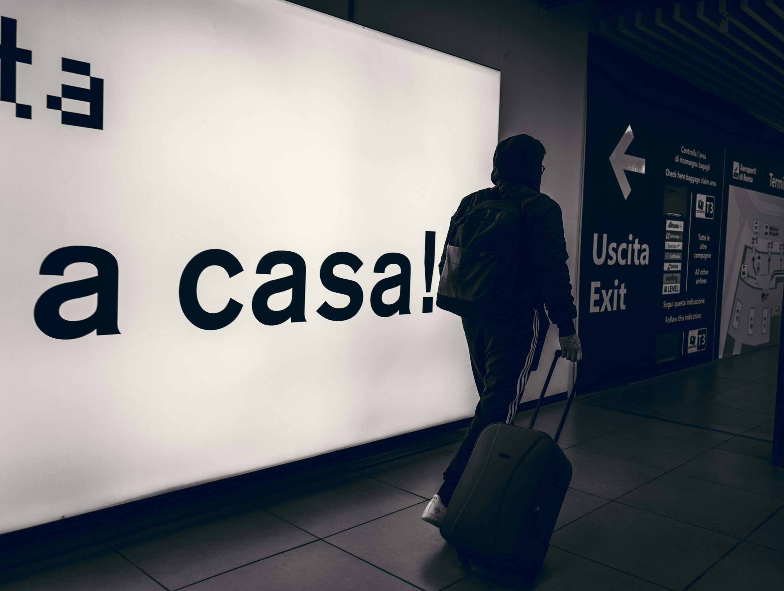 A traveler holding a 'Missing Luggage' sign at an airport terminal