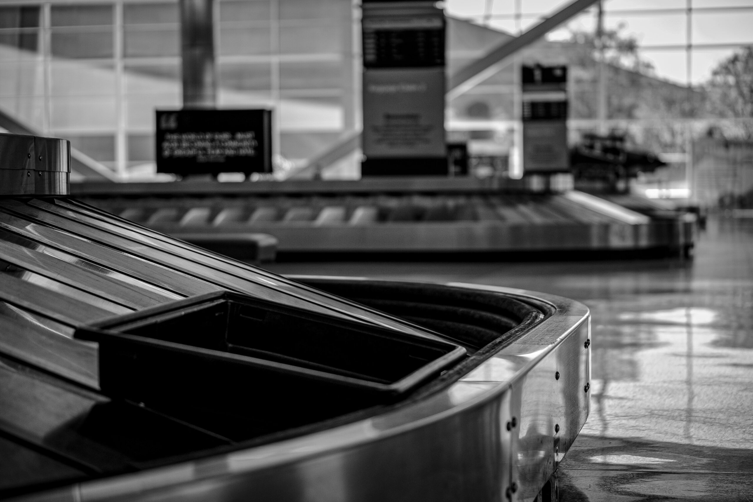 Traveler looking frustrated at empty baggage carousel