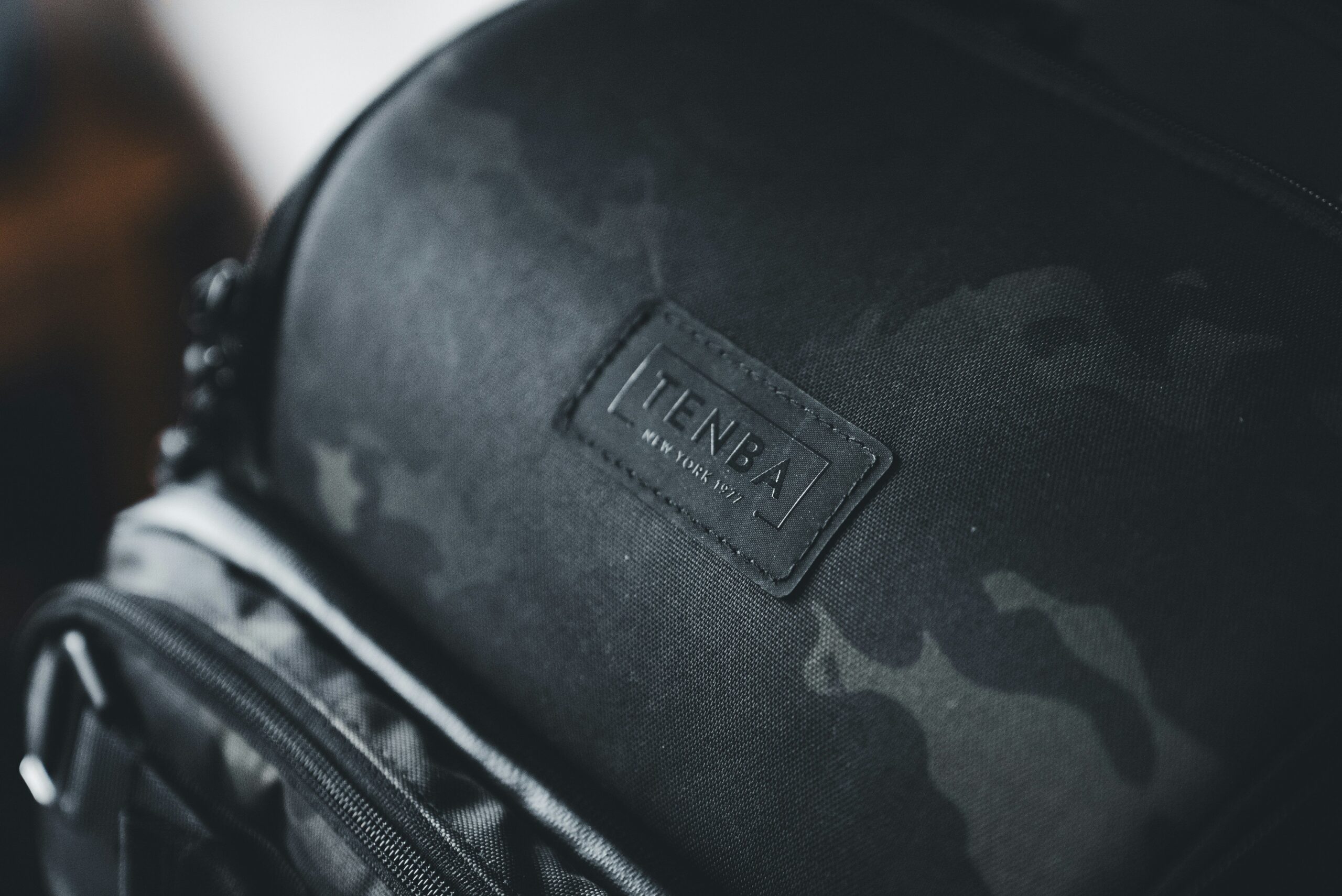 Image of a woman attaching an AirTag to her suitcase