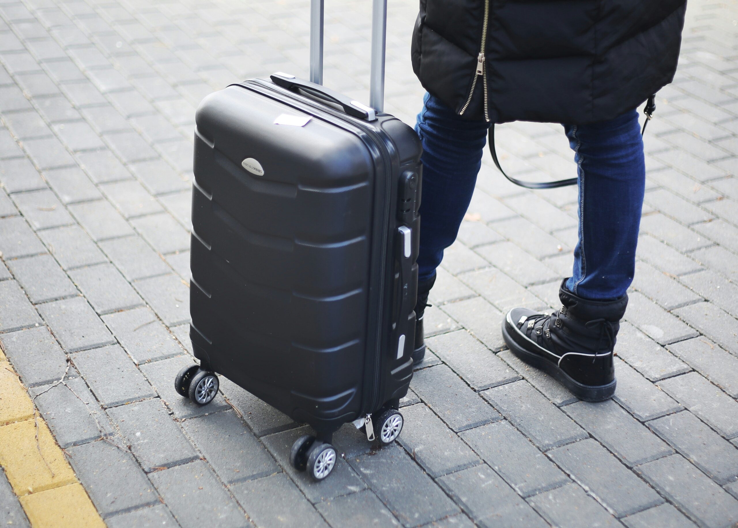 Passenger tagging checked-in luggage at airport counter