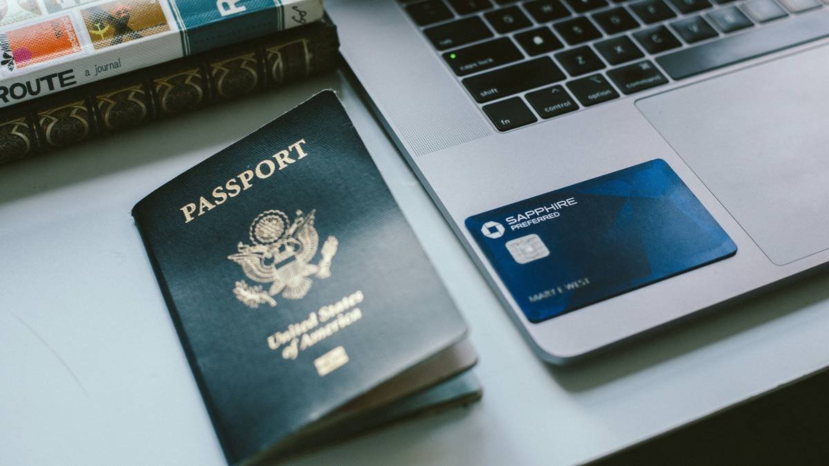 Photo of a traveler holding up a receipt and taking a photo of delayed baggage notice